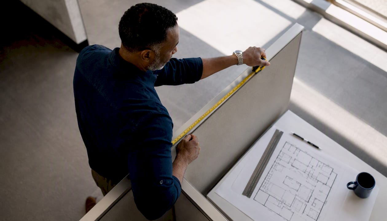 Architect measuring office floor plan details