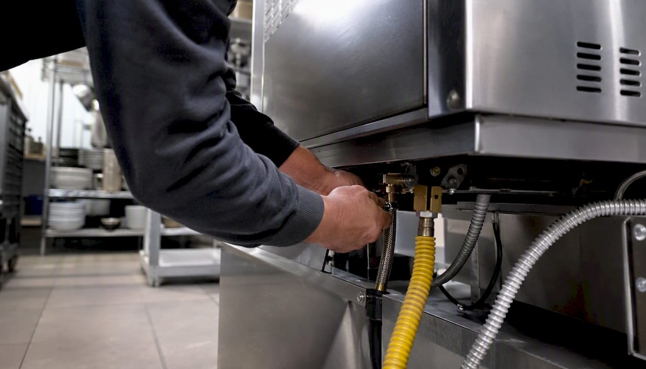 Technician installing commercial kitchen oven