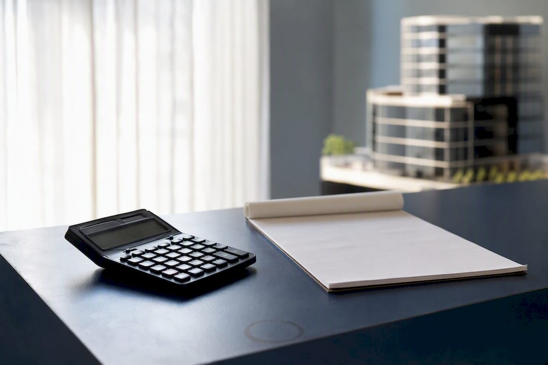 Calculator and blank ledger on office desk