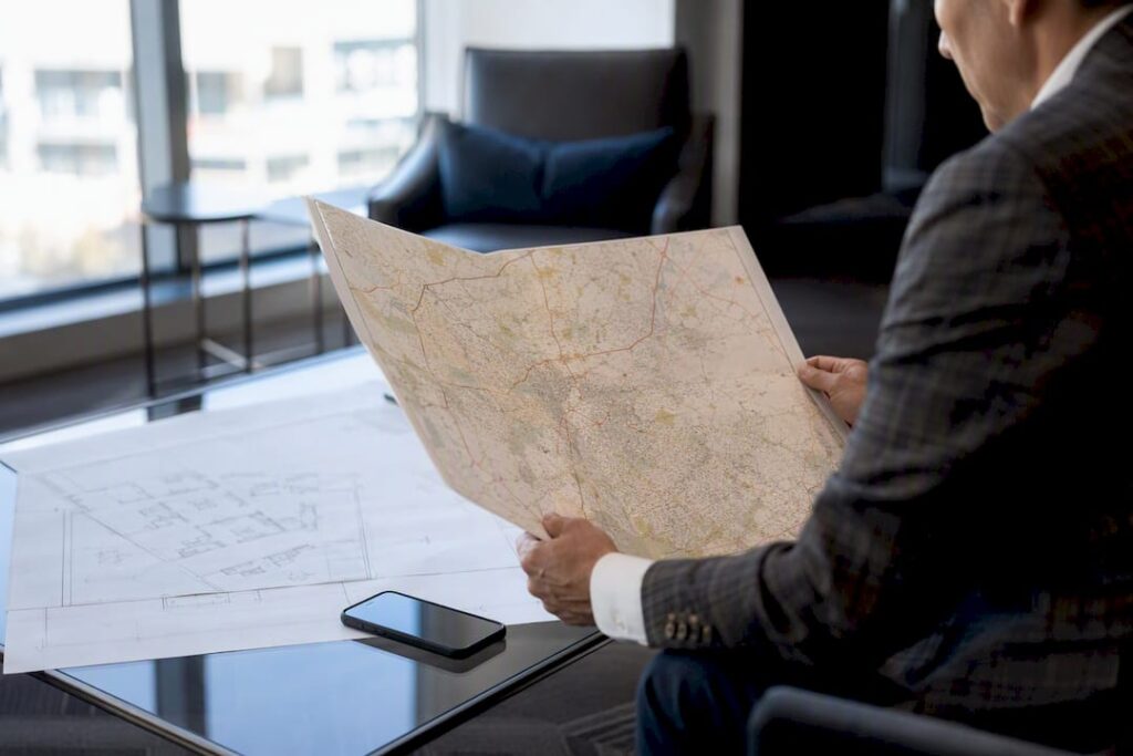 Hands holding Charlotte area map on table