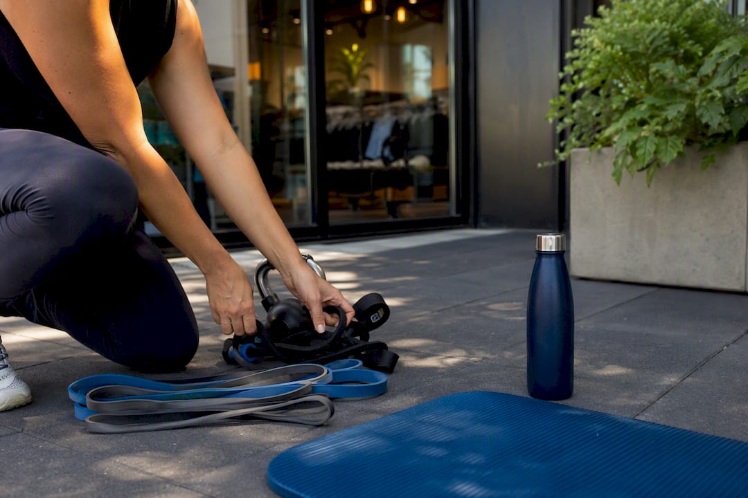 Hands adjusting fitness equipment in boutique studio